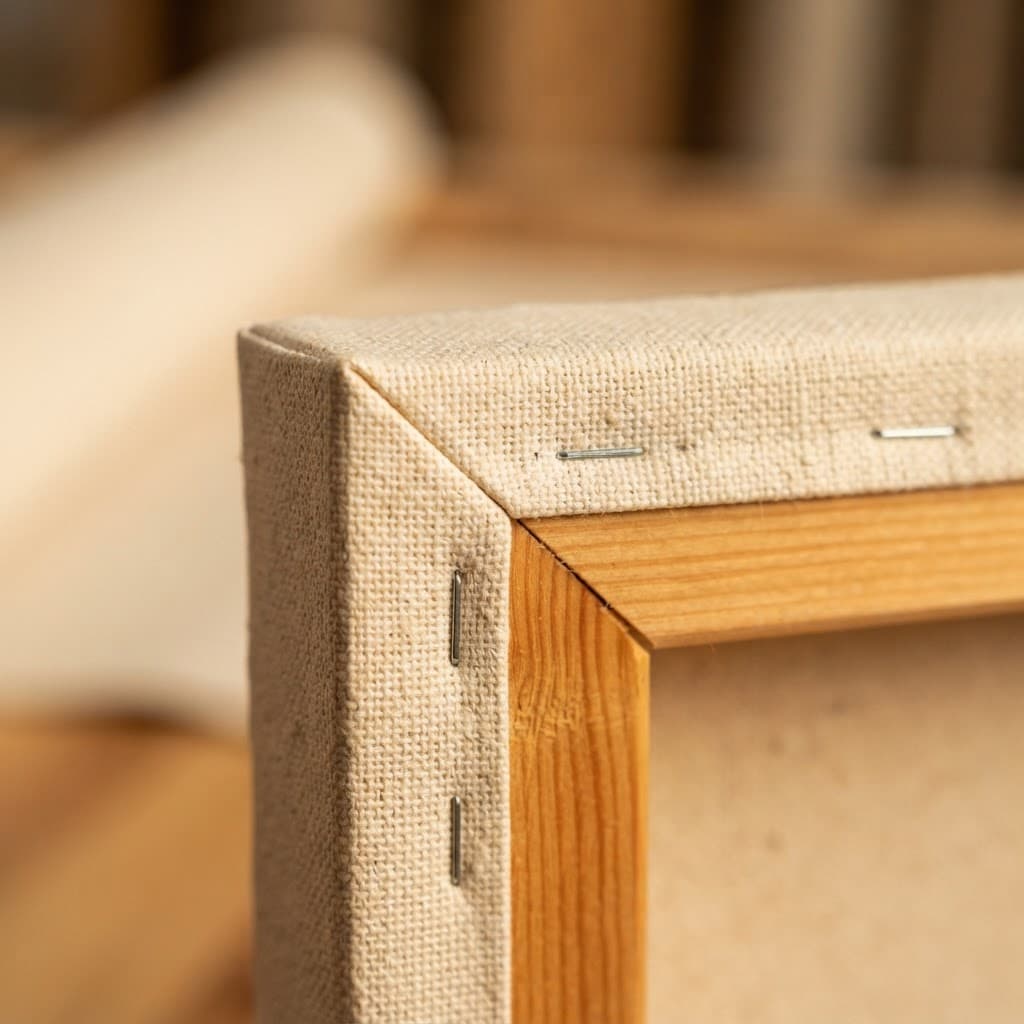 Close-up of premium canvas fabric wrapped around a handcrafted wooden batten frame corner